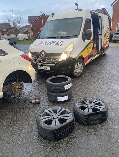 Van beside flat tyres